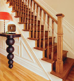 Oak staircase with white moulding on the walls