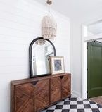 Shiplap focal wall with mirror and black & white checkered floor