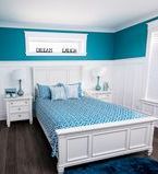 White wainscot wall treatment with window casing in bedroom