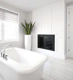 Modern style bathroom with board wall treatment and built in fireplace