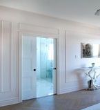 Pocket doors leading to master bathroom with wall treatment