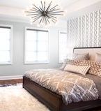 Light grey bedroom with 3 windows with casing and baseboard