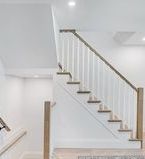 Modern wood staircase, natural wood with white balusters